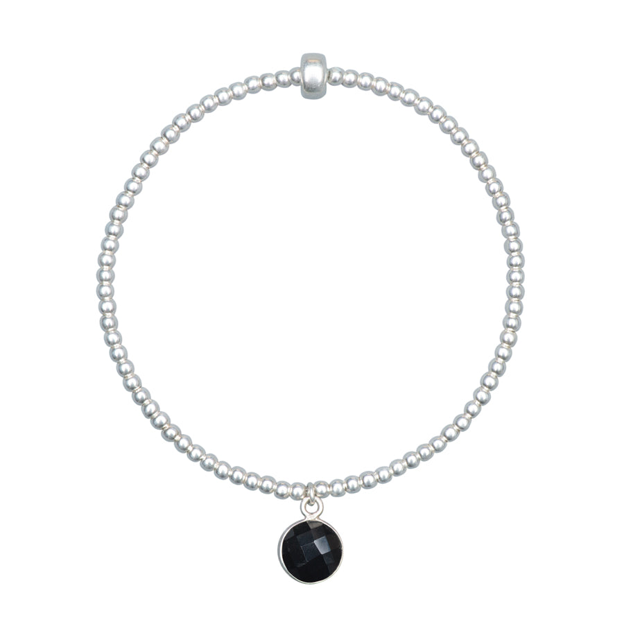 sterling silver beaded stretch bracelet with onyx charm dangling  and displayed on a white background 