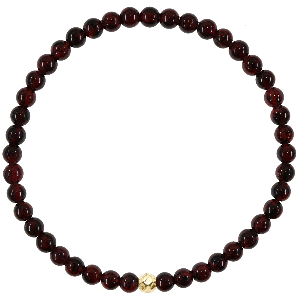 Small round natural garnet gemstone beaded stretch bracelet with gold hammered accent shown on white background